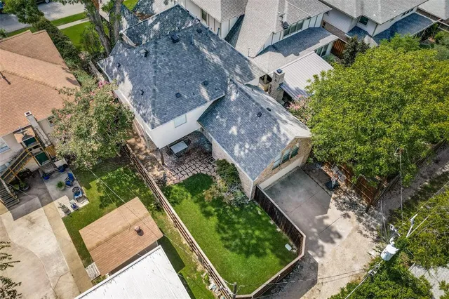 an aerial view of house with a yard