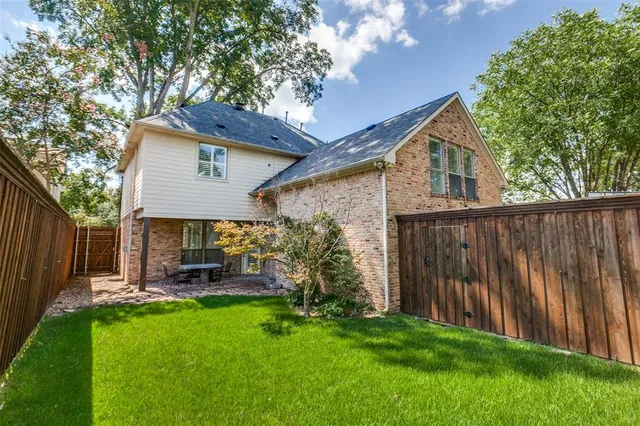 a front view of house with backyard and green space
