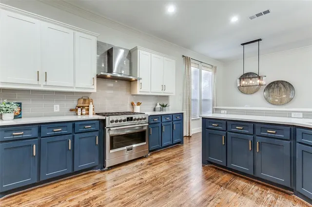 a kitchen with a stove and a wooden floor