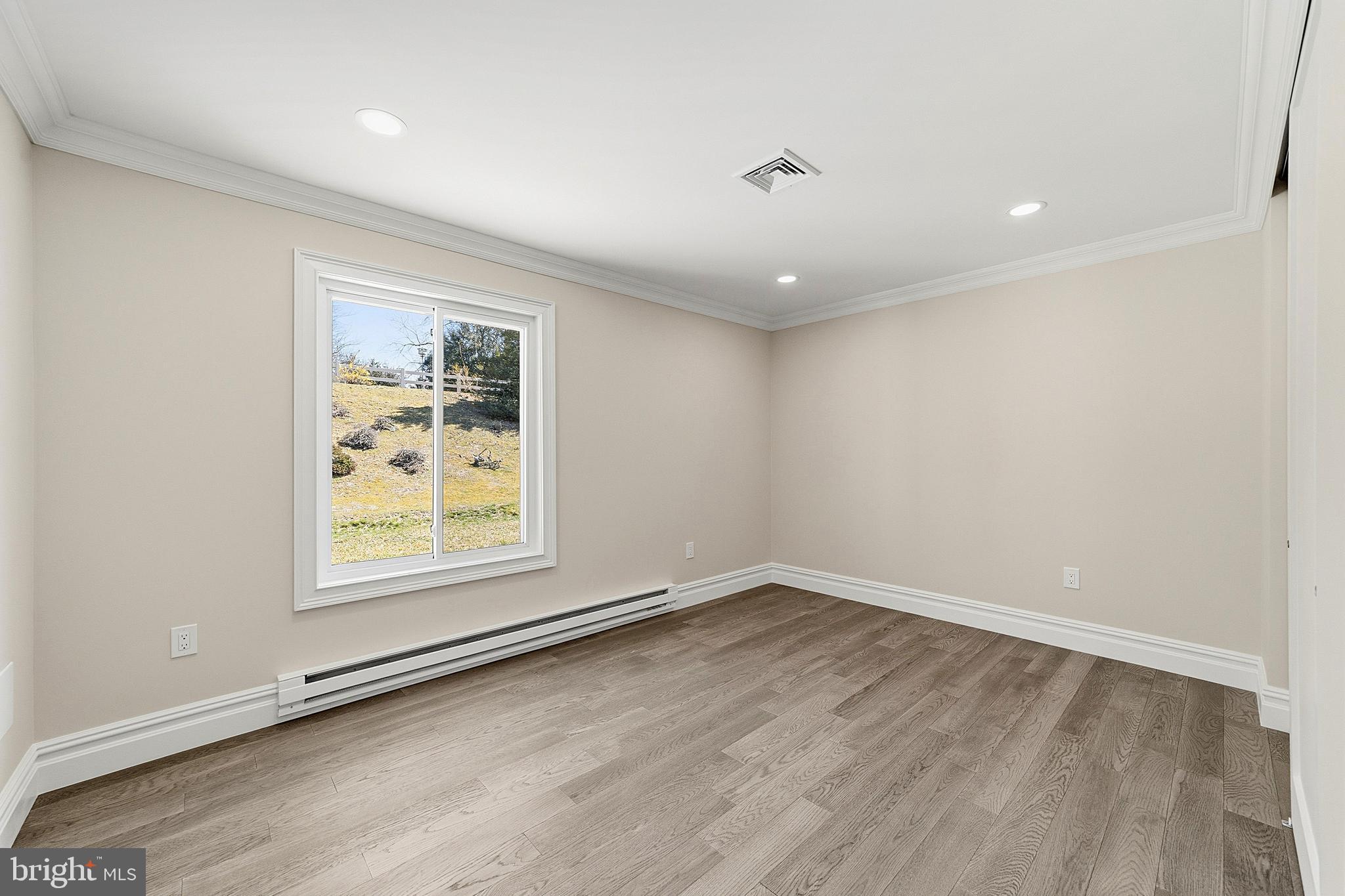 780 Ardmore Road Monroe Township, NJ 08831 - Photo 18 of 30 an empty room with wooden floor and windows