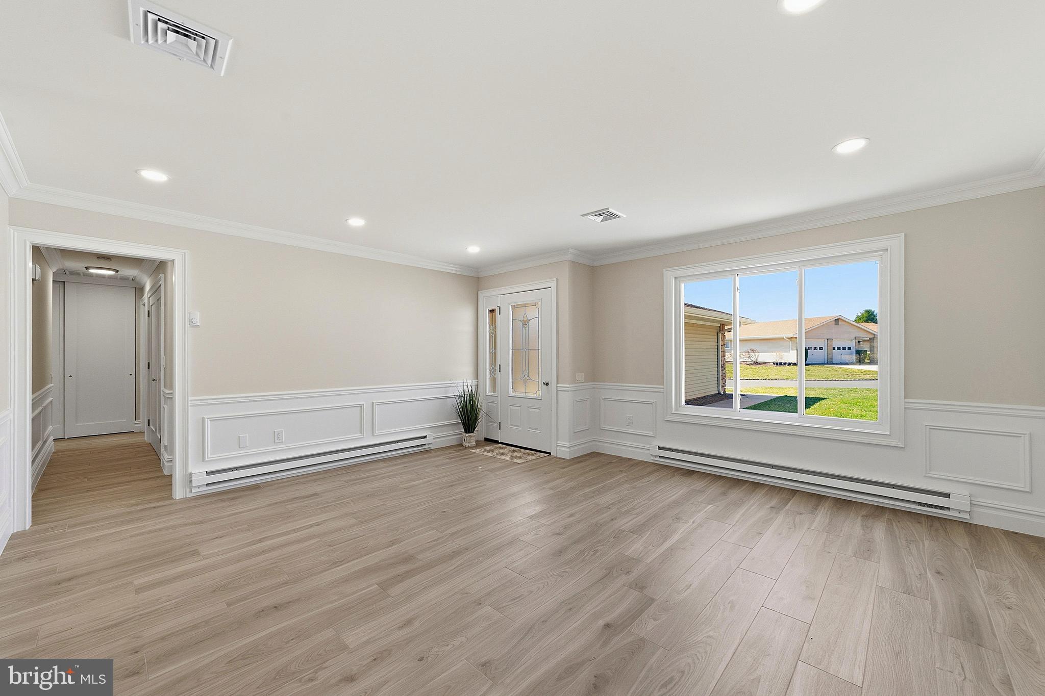 780 Ardmore Road Monroe Township, NJ 08831 - Photo 4 of 30 an empty room with wooden floor and window