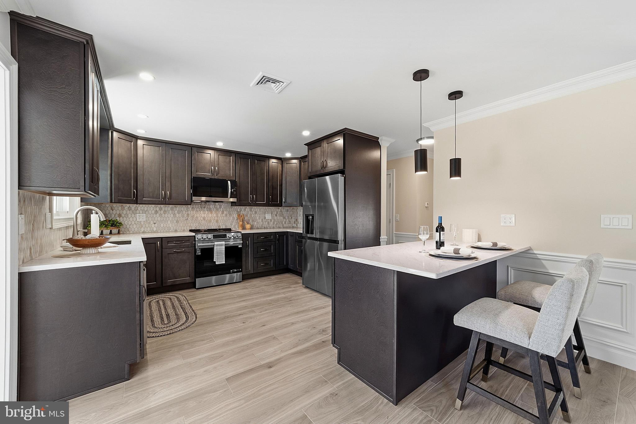 780 Ardmore Road Monroe Township, NJ 08831 - Photo 7 of 30 a kitchen with kitchen island stainless steel appliances a sink stove and refrigerator