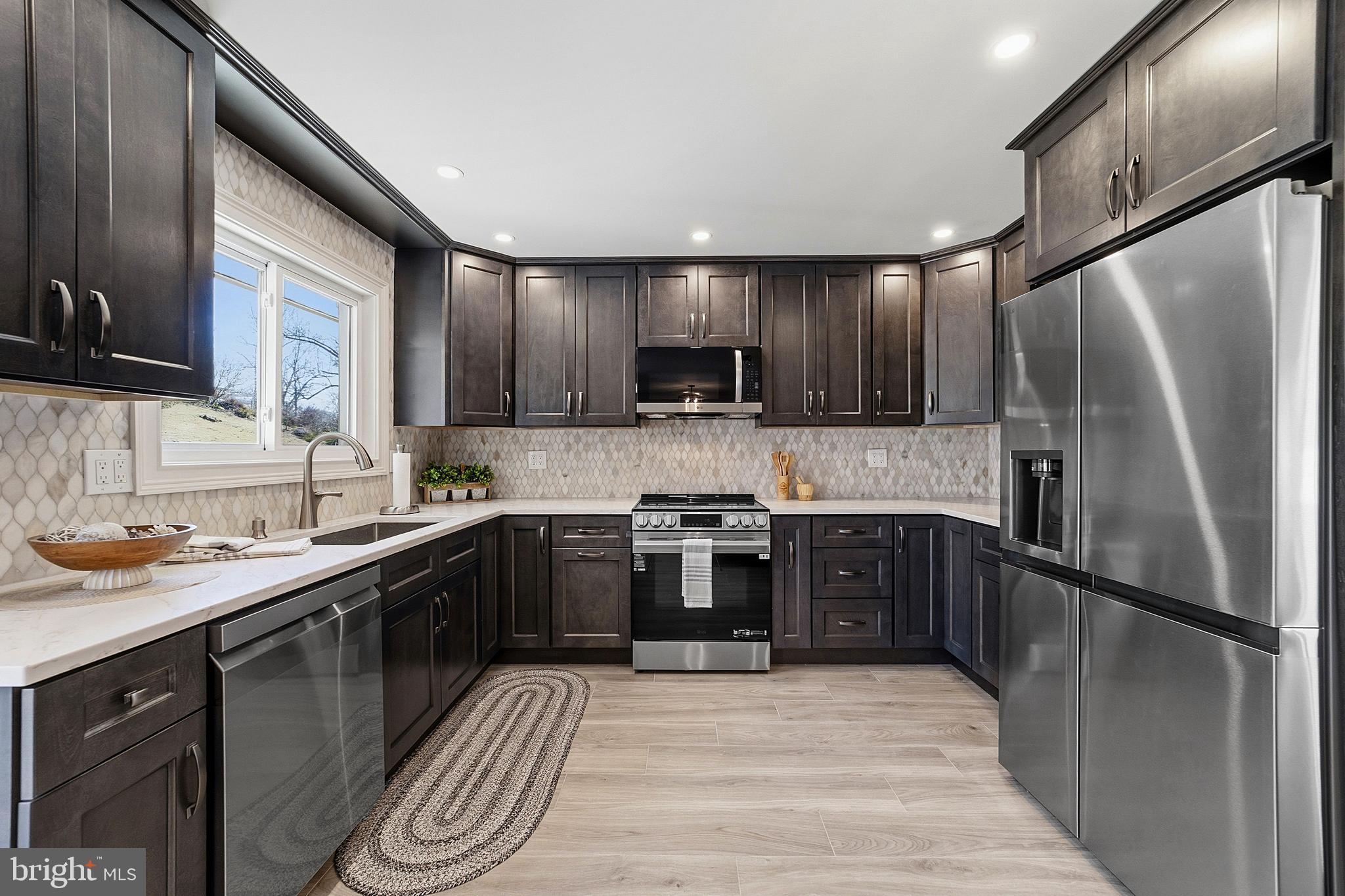 780 Ardmore Road Monroe Township, NJ 08831 - Photo 9 of 30 a kitchen with stainless steel appliances granite countertop a sink stove and refrigerator