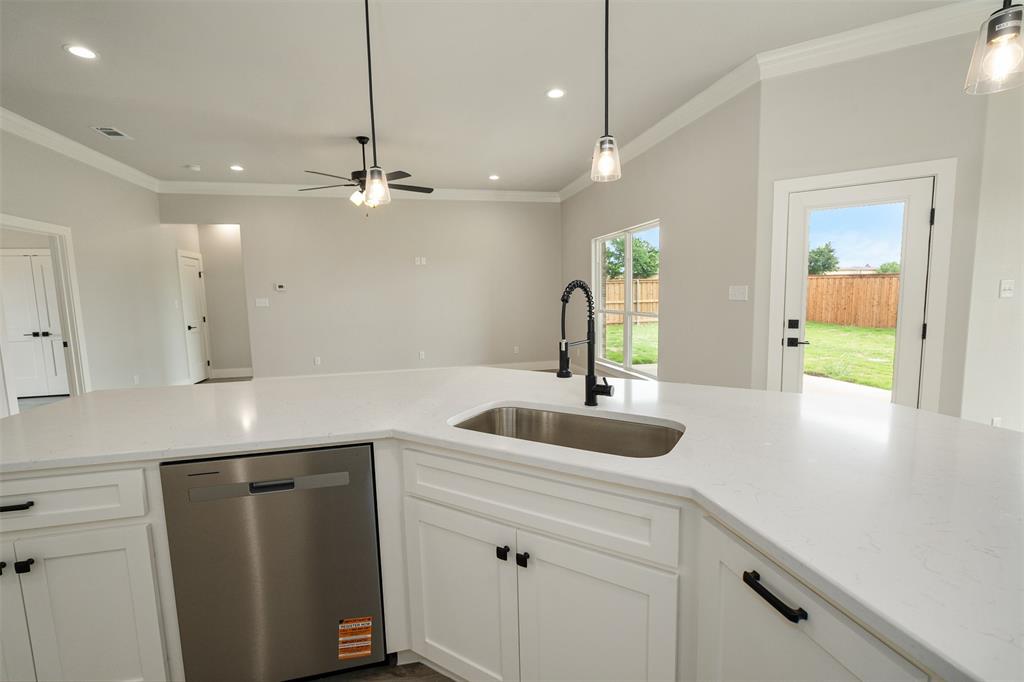 509 Limestone Circle Mabank, TX 75147 - Photo 11 of 36 a kitchen with kitchen island a sink and chandelier