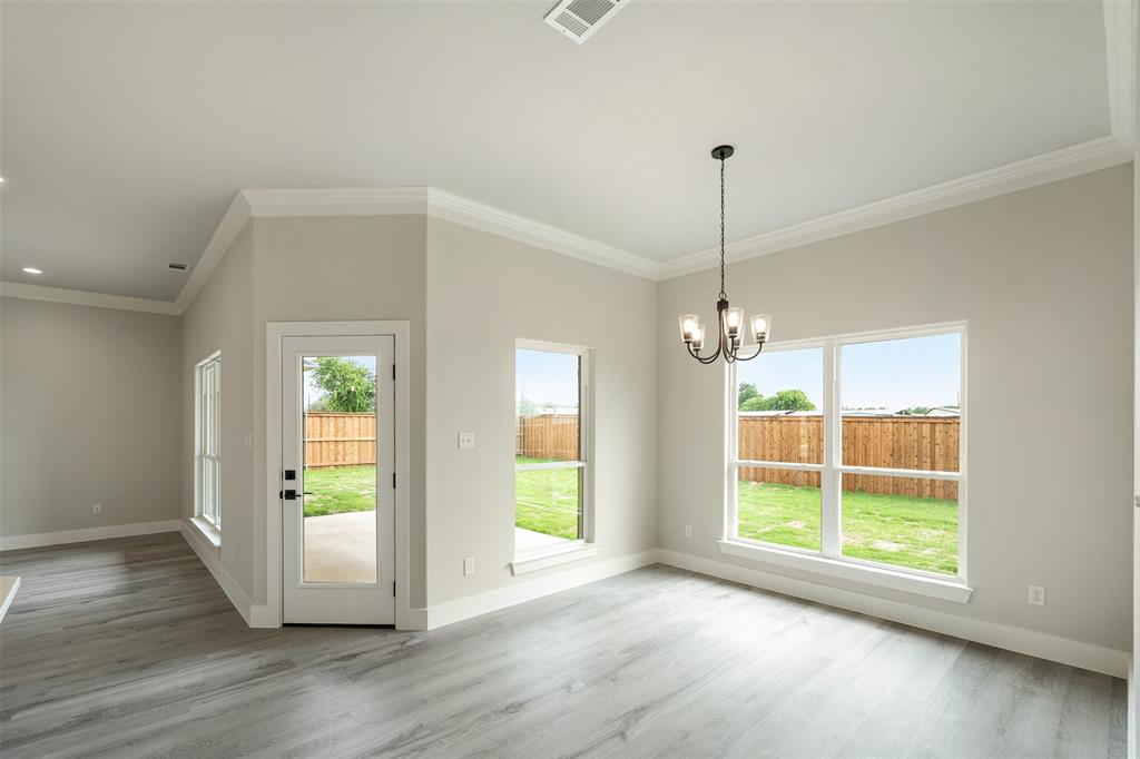509 Limestone Circle Mabank, TX 75147 - Photo 14 of 36 a view of a room with wooden floor chandelier and windows