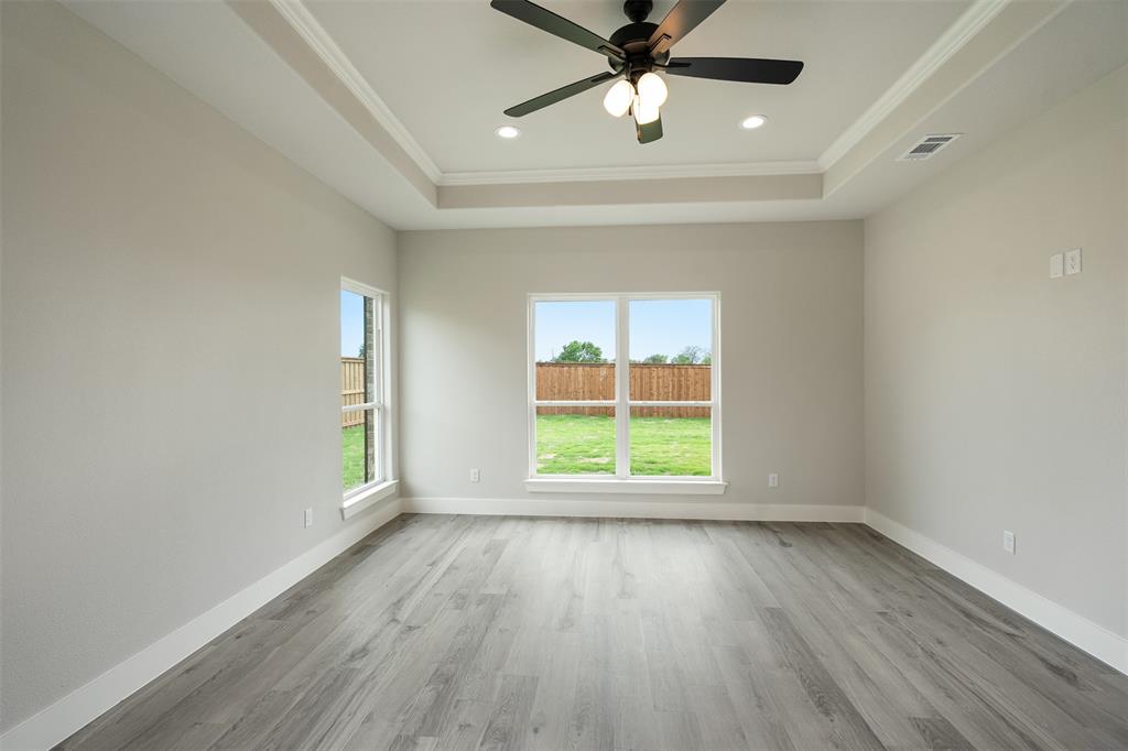 509 Limestone Circle Mabank, TX 75147 - Photo 17 of 36 an empty room with wooden floor fan and windows