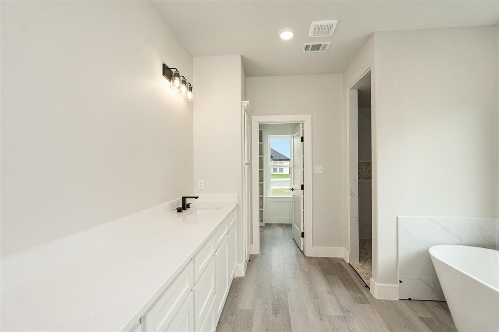 509 Limestone Circle Mabank, TX 75147 - Photo 18 of 36 a view of a bathroom with a tub and shower
