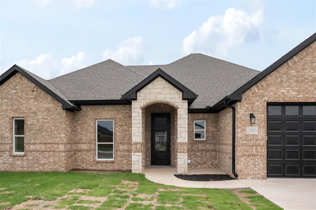 509 Limestone Circle Mabank, TX 75147 - Photo 2 of 36 a front view of a house with a garden