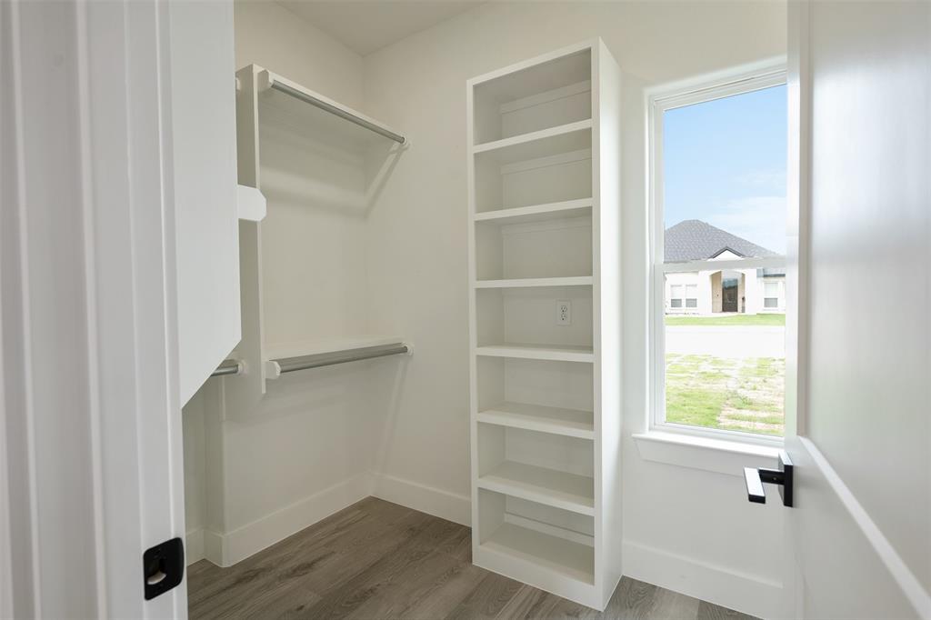 509 Limestone Circle Mabank, TX 75147 - Photo 22 of 36 a view of walk in closet with empty racks