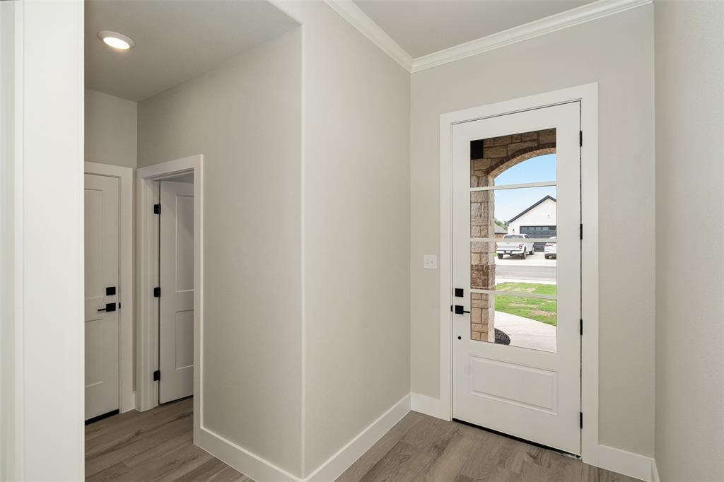 509 Limestone Circle Mabank, TX 75147 - Photo 3 of 36 a view of a hallway with white cabinets and wooden floor