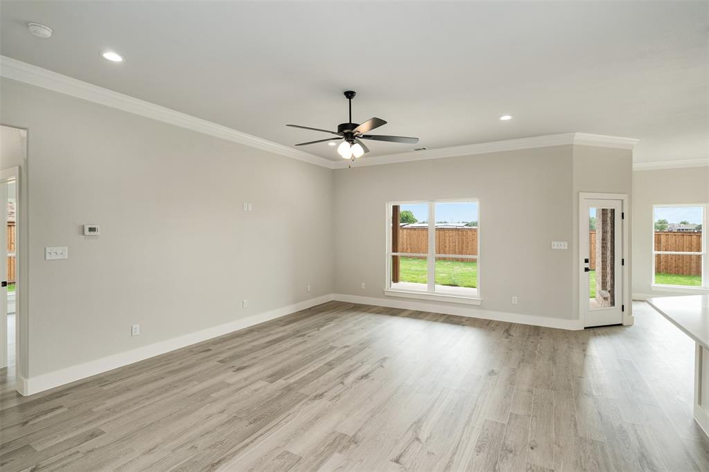 509 Limestone Circle Mabank, TX 75147 - Photo 4 of 36 wooden floor in an empty room with a window