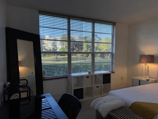 a bedroom with a bed and a window