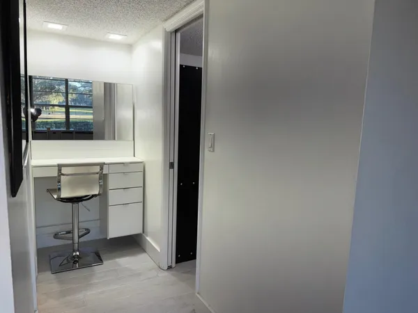 a view of a hallway with bathroom