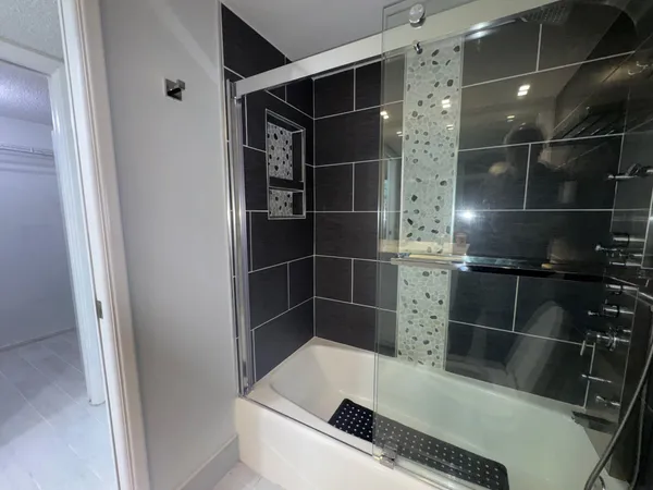 a bathroom with a shower and a sink