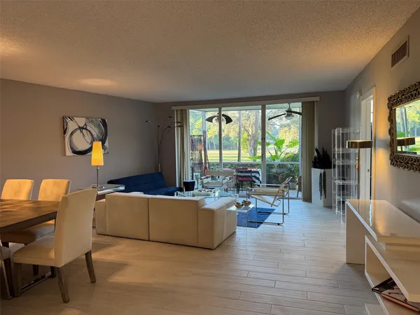 a living room with furniture and large windows