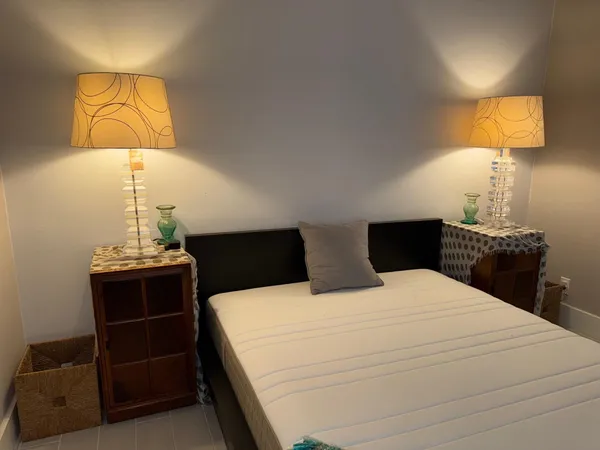 a bedroom with a bed and lamp