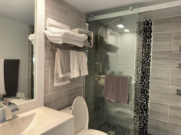 a bathroom with a sink toilet and shower