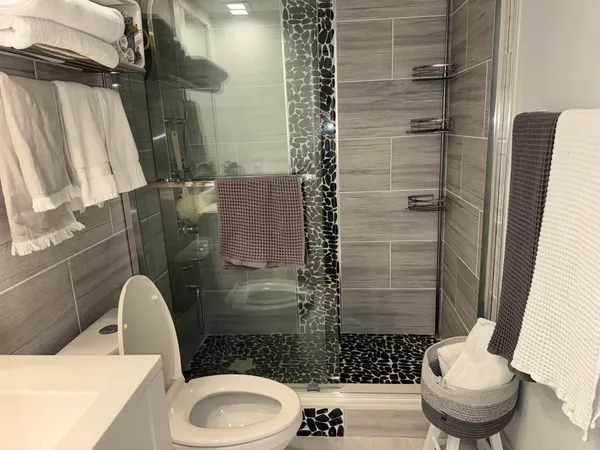 a bathroom with a toilet and a shower