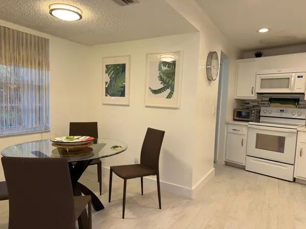 a view of a livingroom with furniture and a window