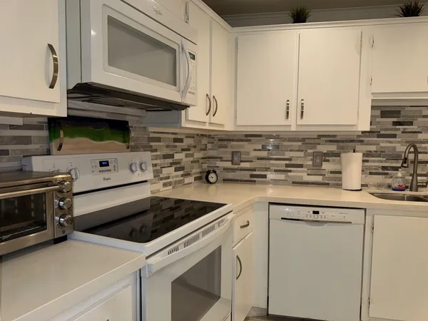 a kitchen with cabinets appliances and a sink