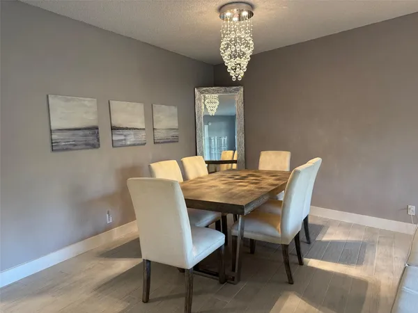a view of a dining room that has a table and chairs