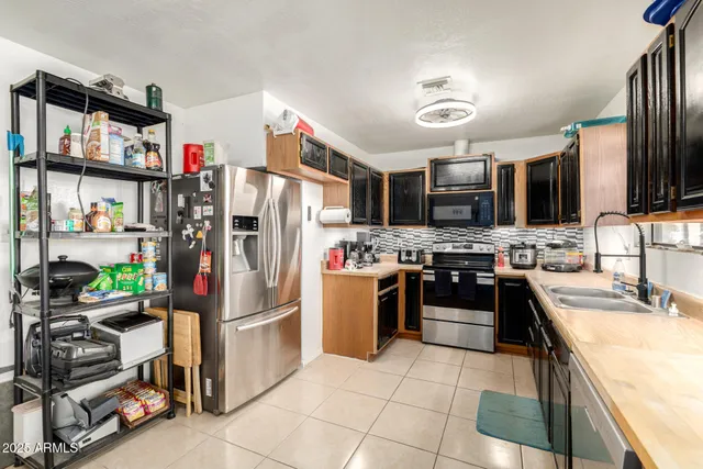 a kitchen with stainless steel appliances granite countertop a stove microwave and refrigerator