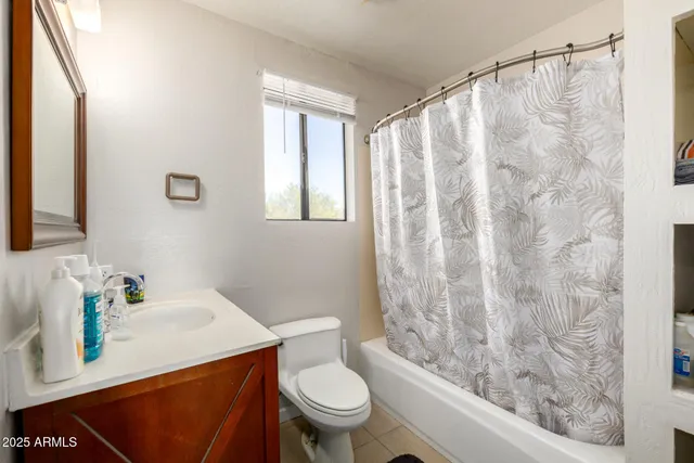 a bedroom with a bed and a ceiling fan