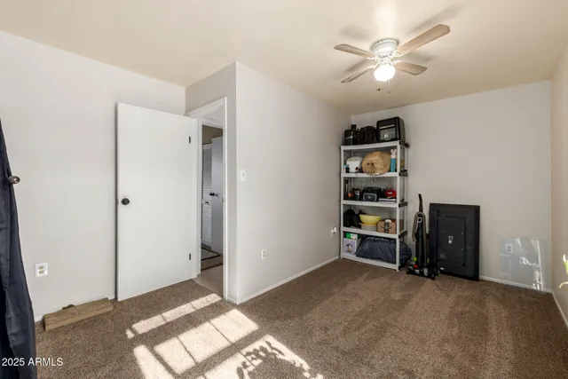 a view of a livingroom with workspace and a window