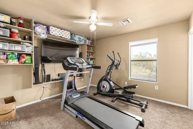 a view of a bedroom with workspace and a window