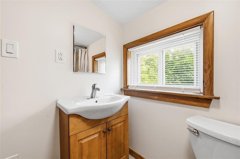 123 Cemetery Road Slippery Rock, PA 16057 - Photo 21 of 33 This updated bathroom features a pedestal-style vanity and a large window that fills the space with natural light.
