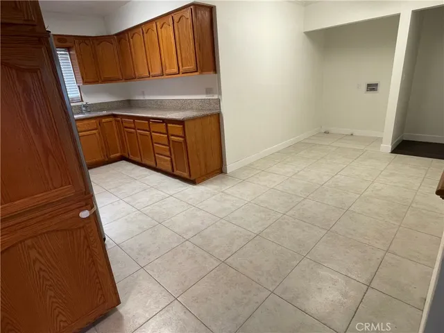 a kitchen with granite countertop a sink and a stove top oven