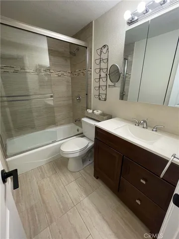 a bathroom with a double vanity sink toilet and shower