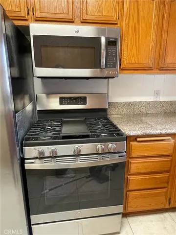 a stove top oven sitting inside of a kitchen