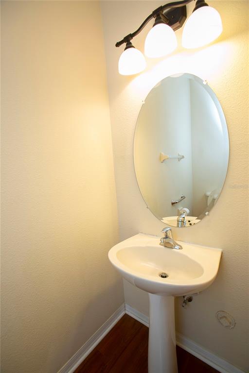 11919 Essington Street New Port Richey, FL 34654 - Photo 6 of 46 a bathroom with a sink a mirror and vanity