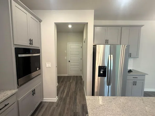 a kitchen with stainless steel appliances granite countertop a refrigerator and a sink
