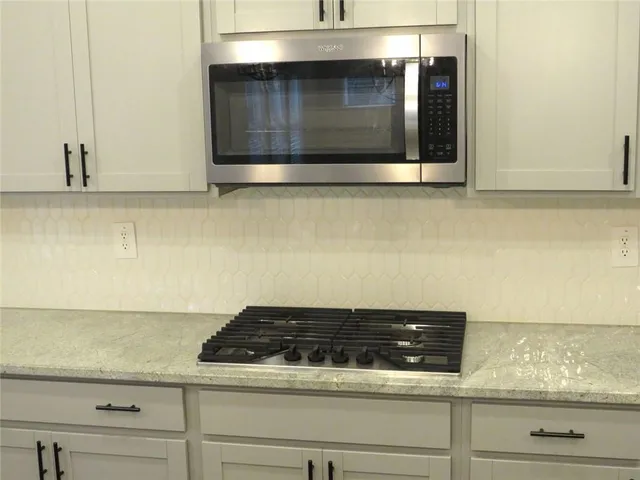 a close view of a stove top oven sitting inside of a kitchen