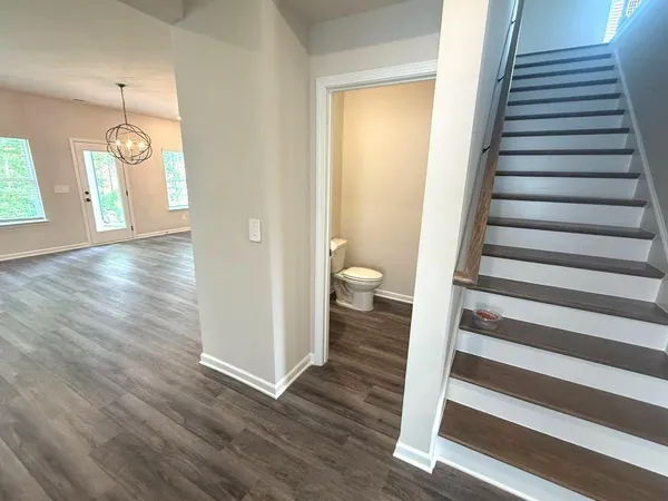 a view of a room with wooden floor and windows