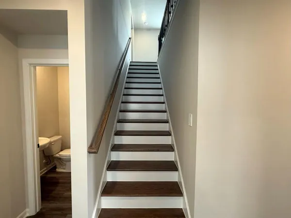 a view of a hallway with wooden floor and entryway