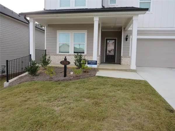 a view of a house with backyard and porch
