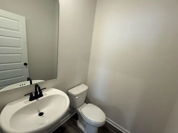 a white toilet sitting next to a bathroom sink