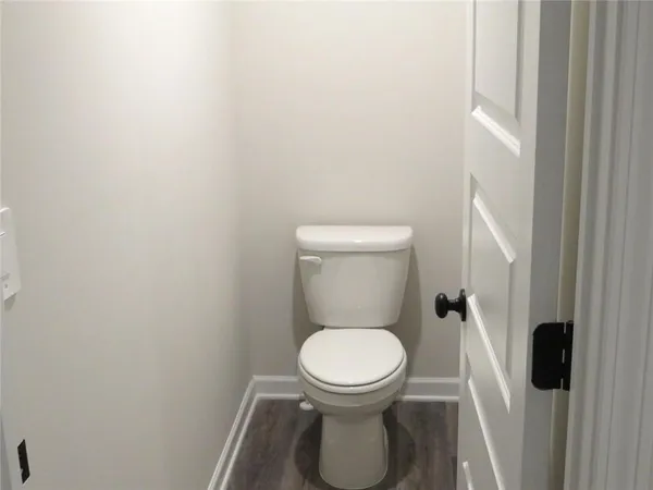 a white toilet sitting next to a shower