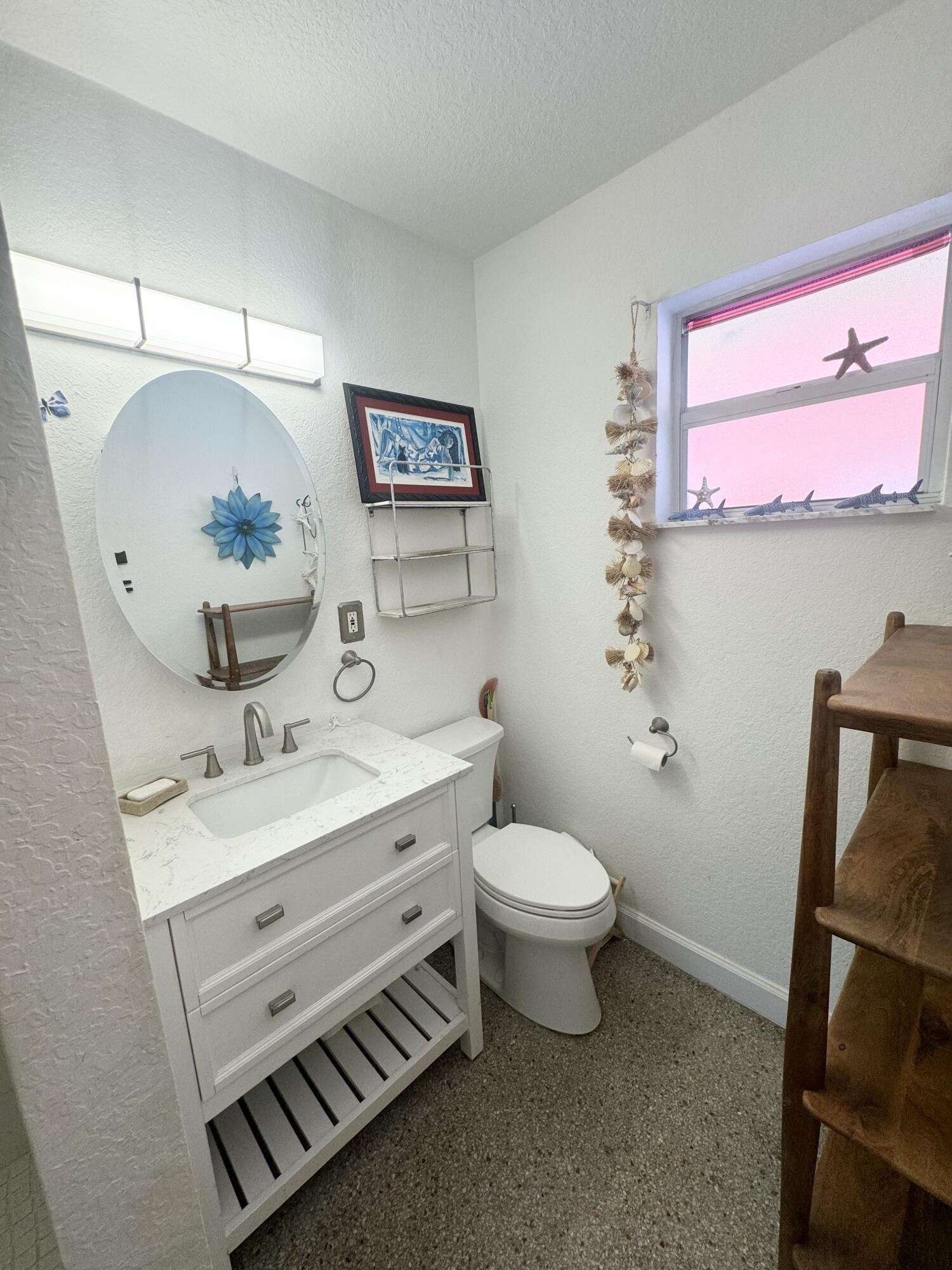 11 Tropical Drive, Unit 2 Ocean Ridge, FL 33435 - Photo 11 of 12 a bathroom with a toilet sink and mirror