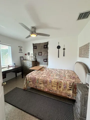 a bedroom with bed and window