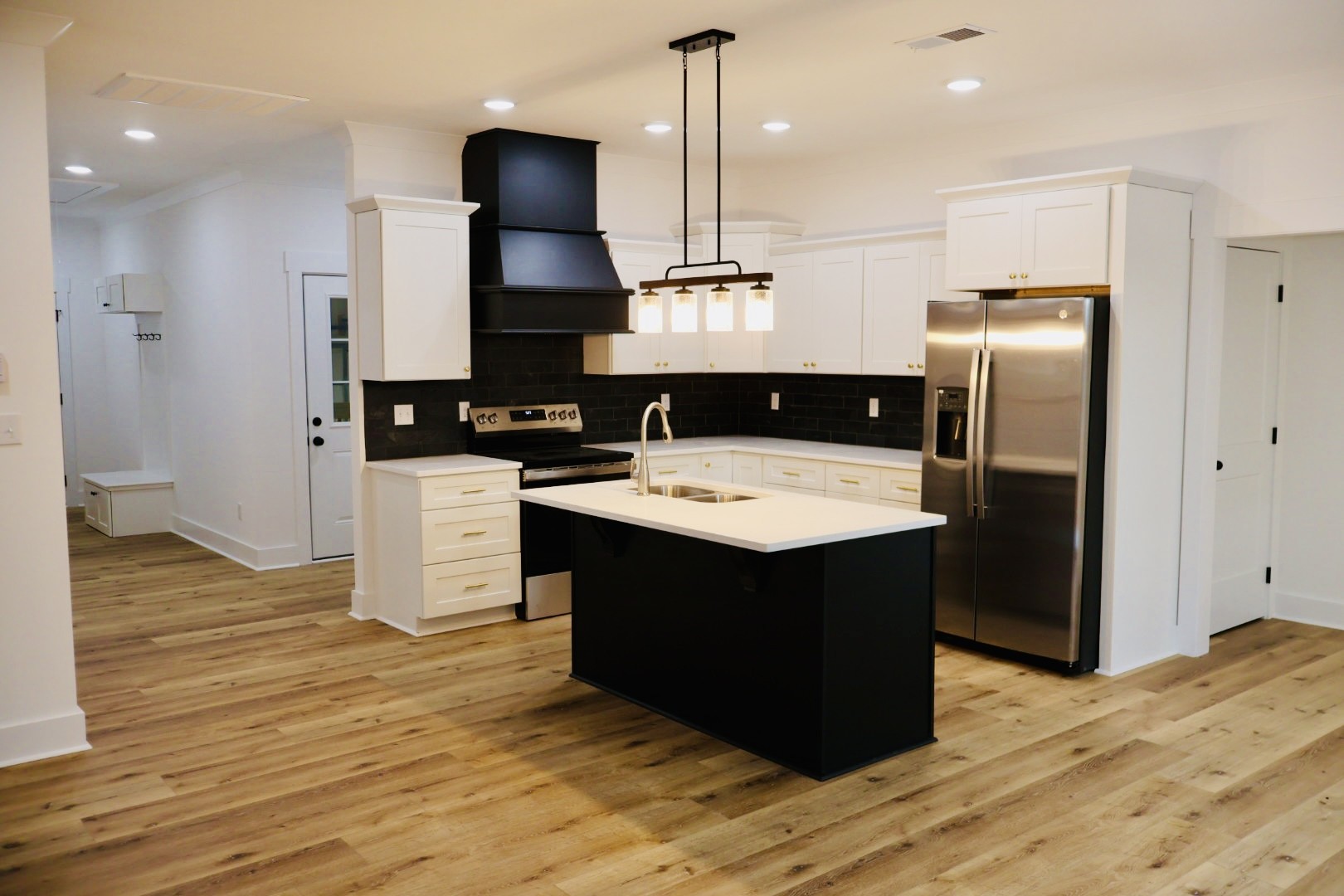 62 Hall Street Lexington, TN 38351 - Photo 14 of 48 a kitchen with stainless steel appliances granite countertop a refrigerator a sink a stove and wooden floor