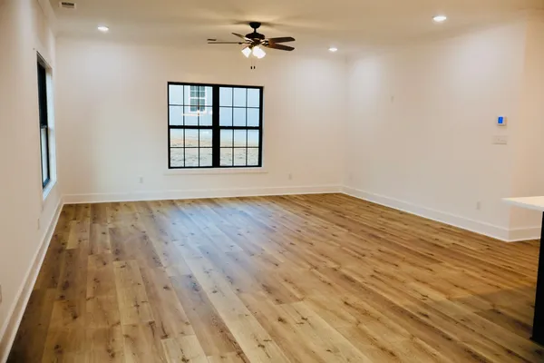 a kitchen with stainless steel appliances granite countertop a sink a stove and a wooden floors
