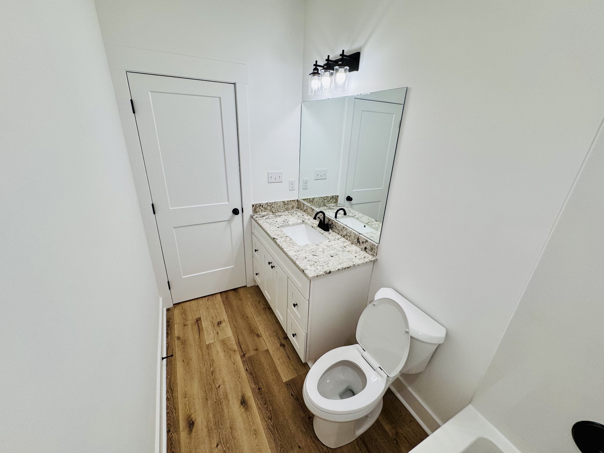 62 Hall Street Lexington, TN 38351 - Photo 23 of 48 a bathroom with a granite countertop toilet sink and mirror