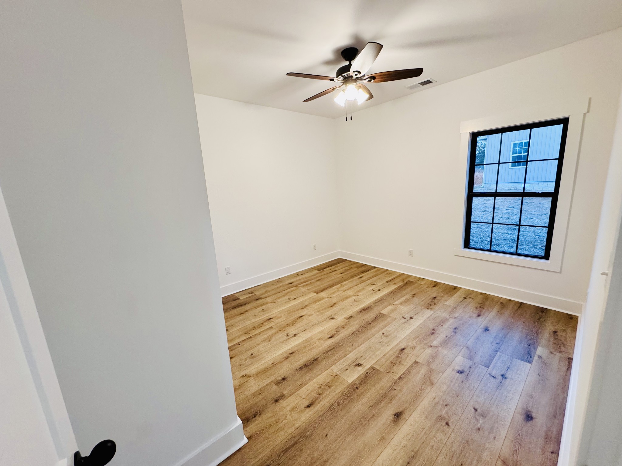 62 Hall Street Lexington, TN 38351 - Photo 24 of 48 a view of empty room with wooden floor and fan