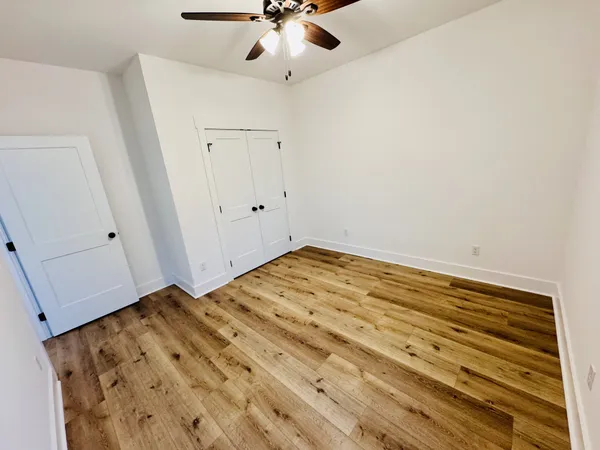 a kitchen with kitchen island white cabinets and refrigerator