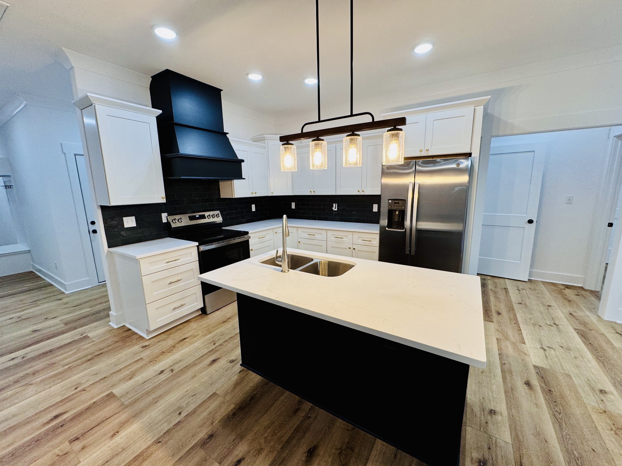 62 Hall Street Lexington, TN 38351 - Photo 27 of 48 a kitchen with kitchen island white cabinets and refrigerator