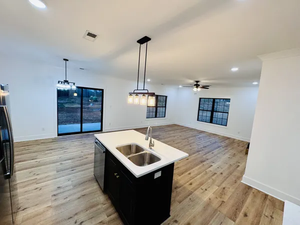 a kitchen with a sink a stove and refrigerator